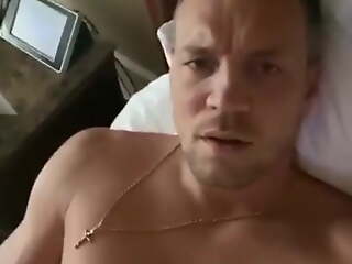 Russian footballer Artem Dzyuba bringing off on hotel bed